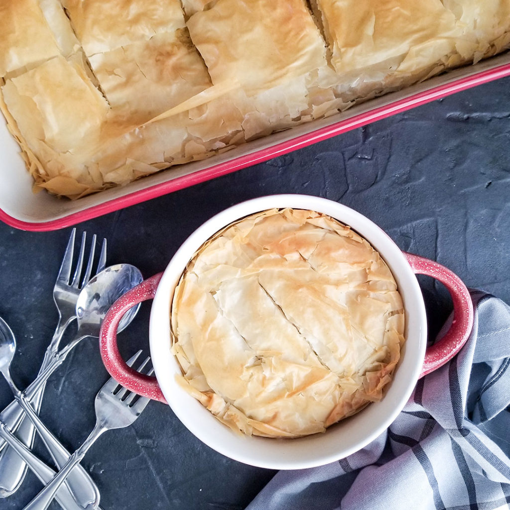 baked chicken pot pie in a pan and individual serving dish