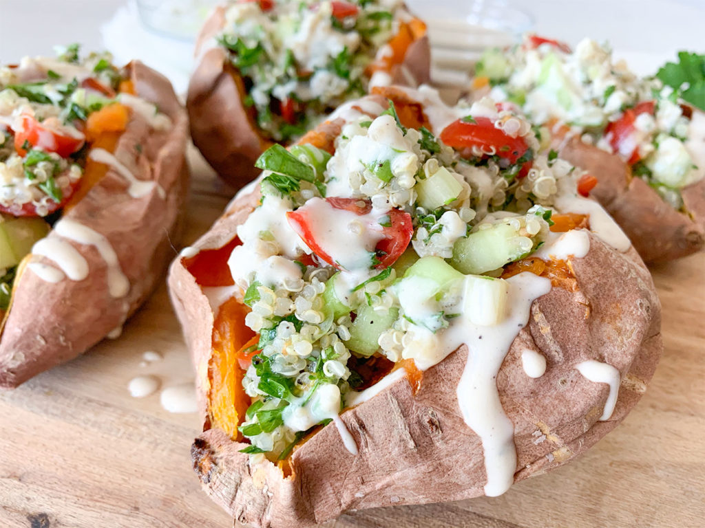 baked sweet potatoes stuffed with tabouli and tahini drizzle