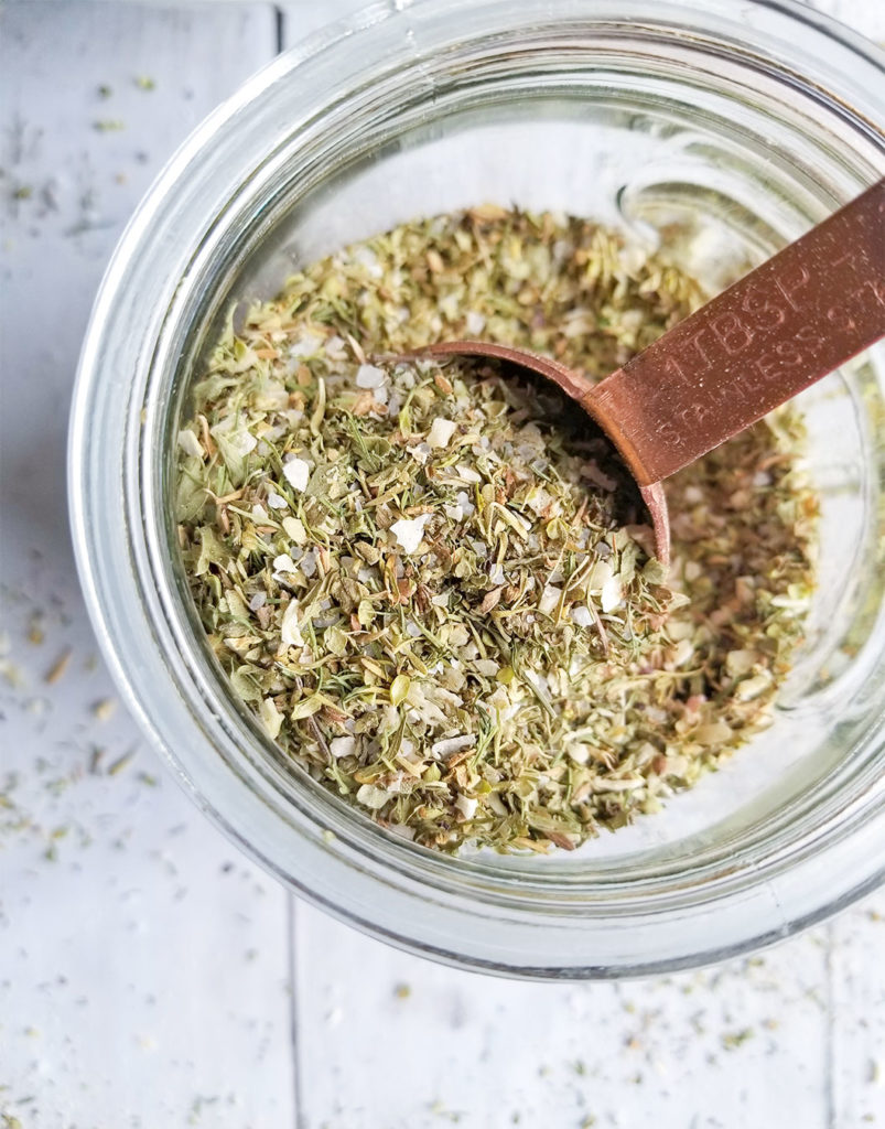 Greek Spice Blend in a bowl with a tablespoon