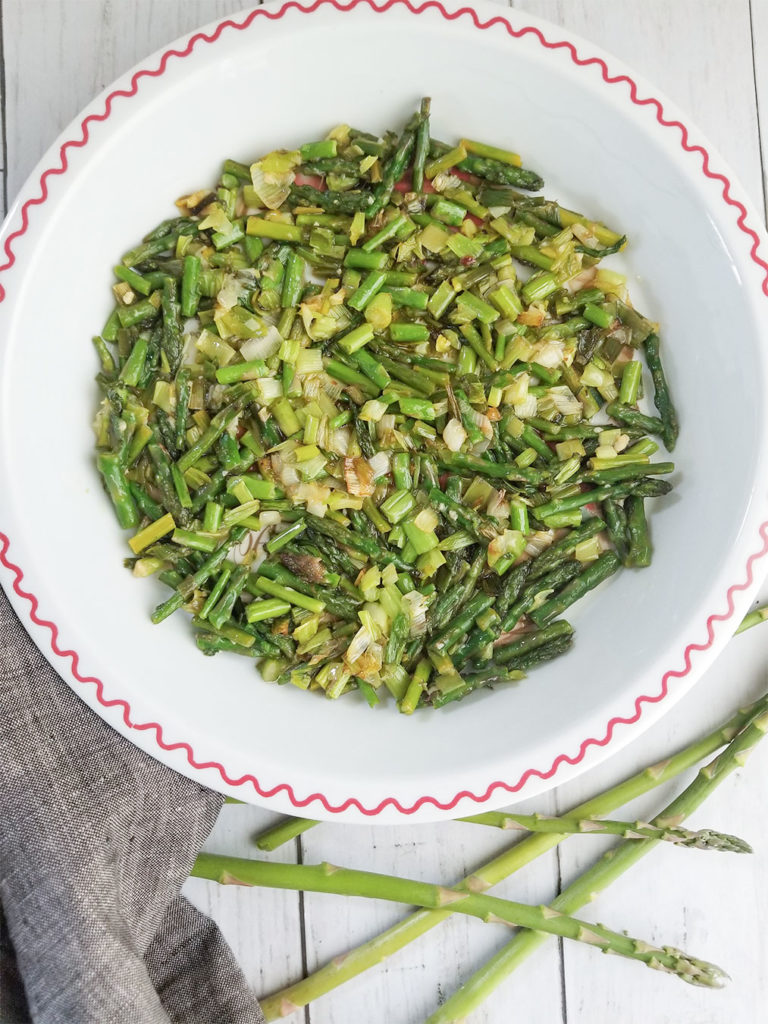 Sautéed asparagus and green onion in a pan