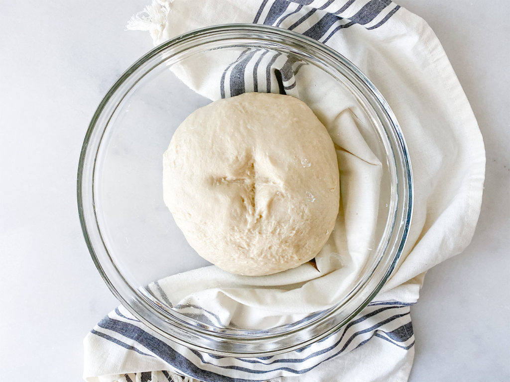 tsoureki dough in a bowl with olive oil