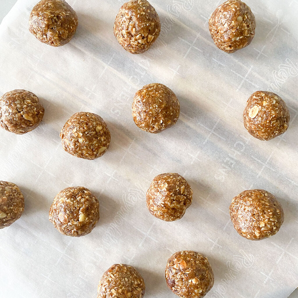 No-Bake Baklava Protein Balls formed on parchment paper