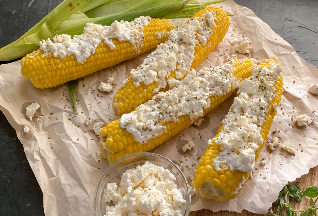 Greek Style Corn On The Cob with a sprinkle of oregano