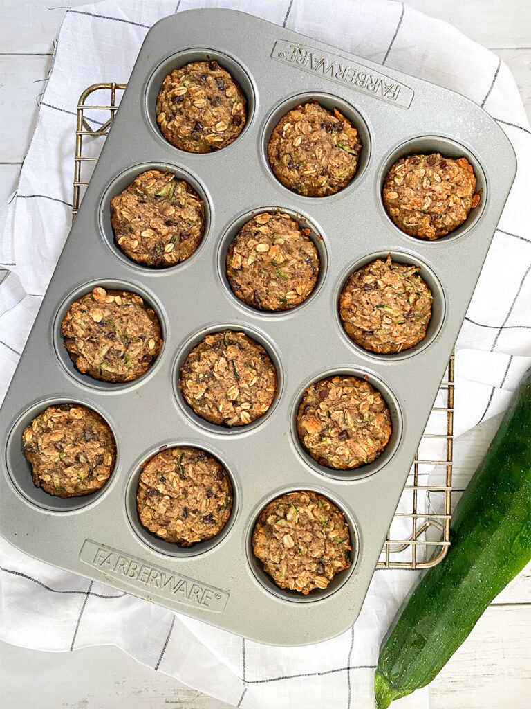 baked zucchini muffins in a muffin tin