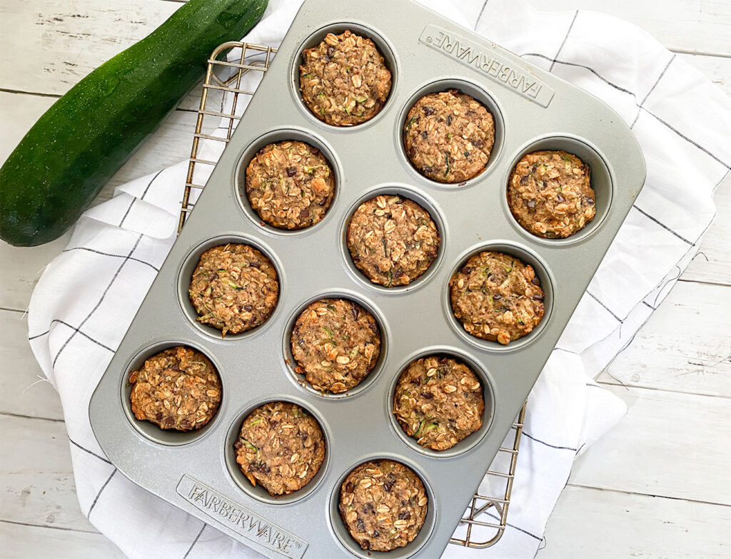 baked zucchini muffins in a muffin tin