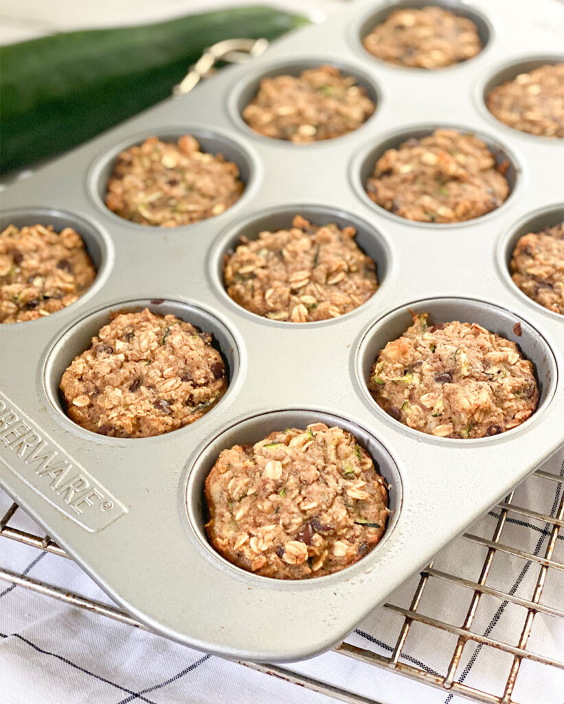 baked zucchini muffins in a muffin tin
