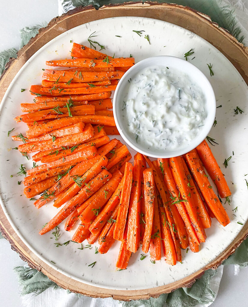 Carrot fries on a plate served with a tzatziki dipping sauce