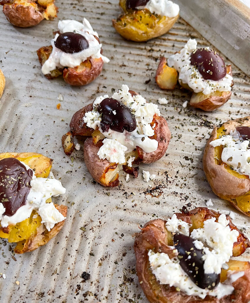 baked smashed potatoes with feta cheese and kalamata olives