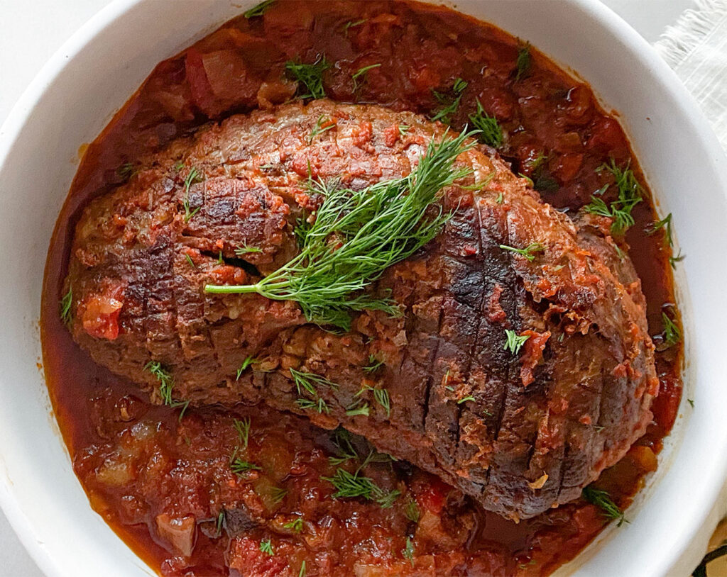 roasted lamb in a red sauce