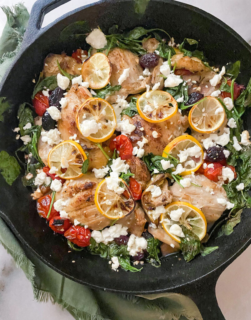 chicken thighs with vegetables in a cast iron skillet