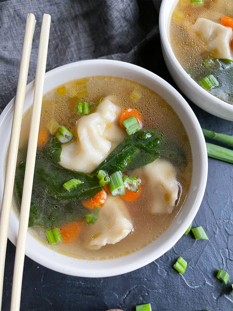 soup with pot stickers, carrots, celery, green onion