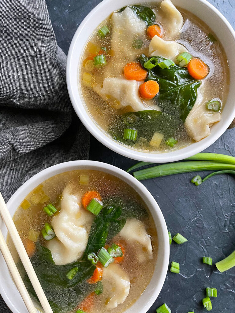 Bowls of potsticker soup with vegetables