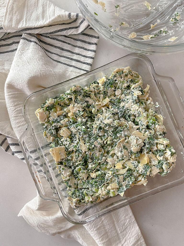 spinach artichoke feta dip in a glass baking dish