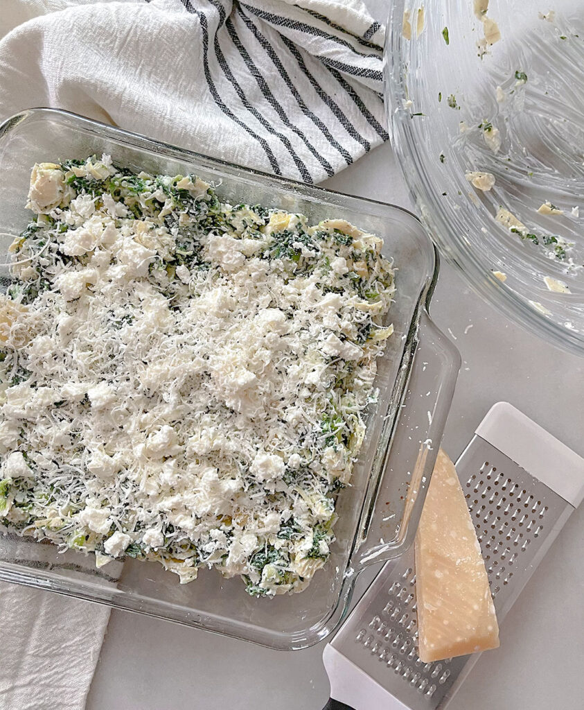 spinach artichoke feta dip topped with extra cheese