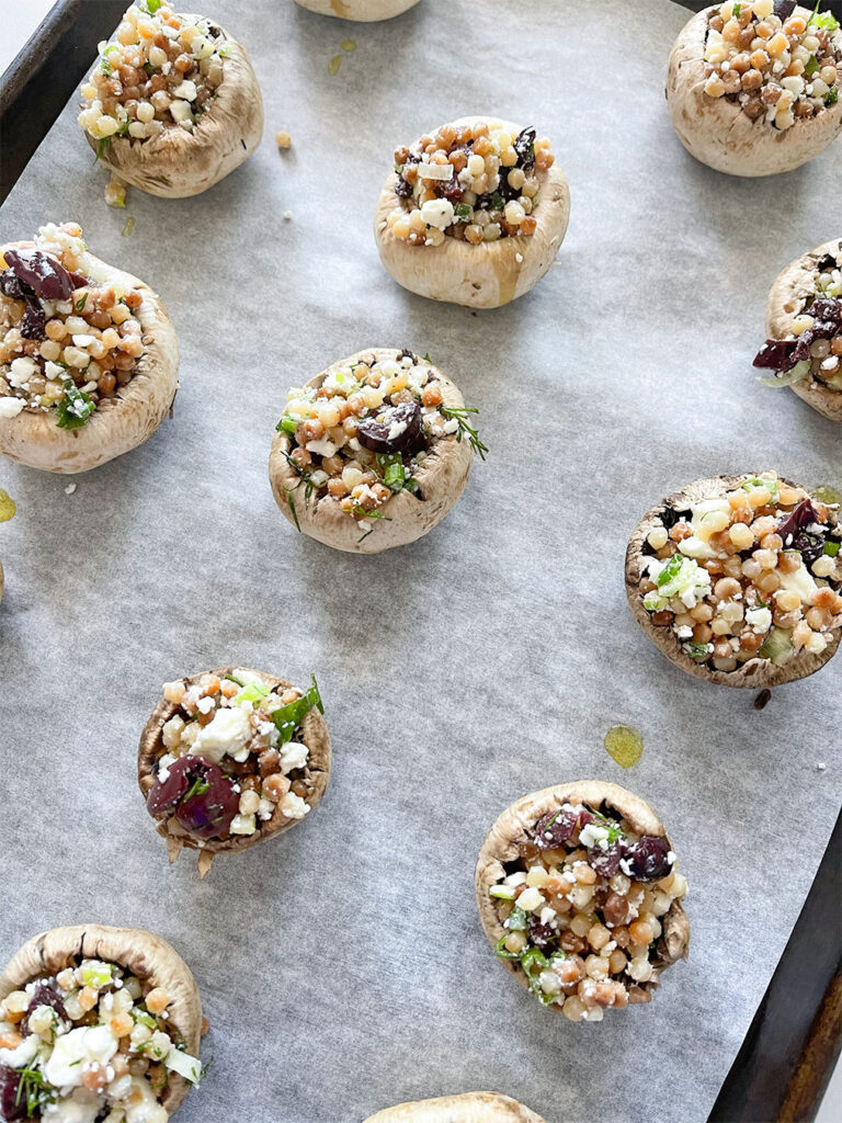 stuffed mushrooms on a baking sheet