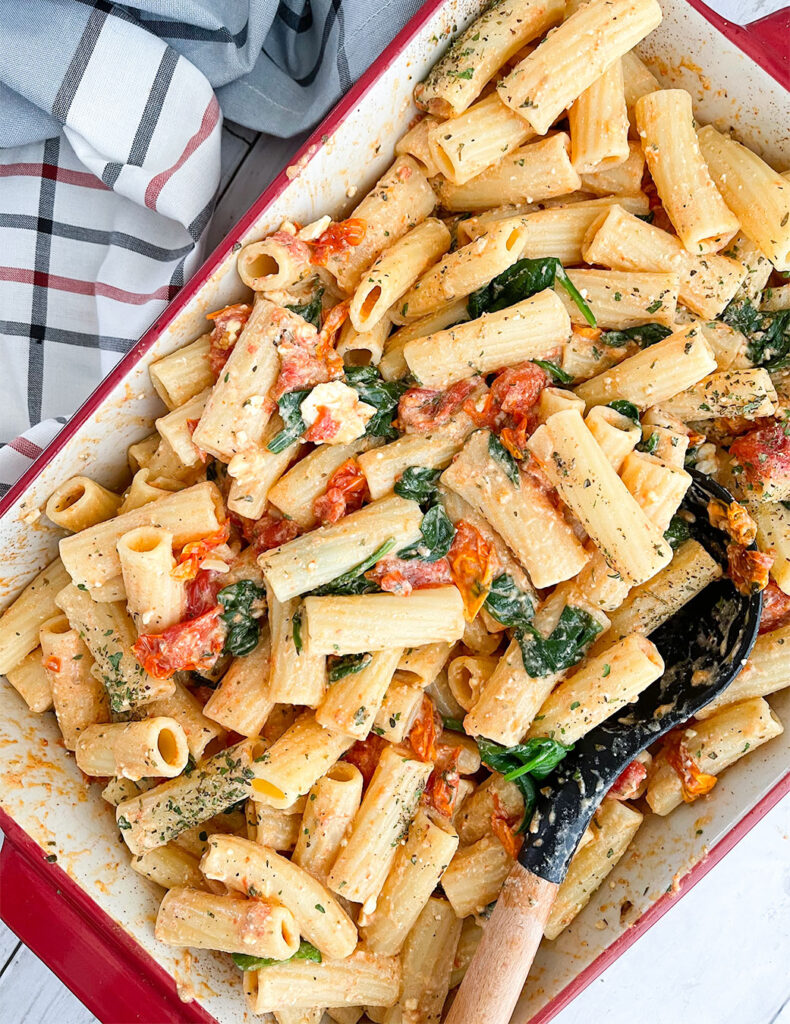 baked tomatoes and feta cheese tossed with pasta, spinach and spices