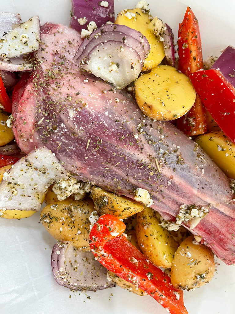 raw lamb shank with vegetables and spices