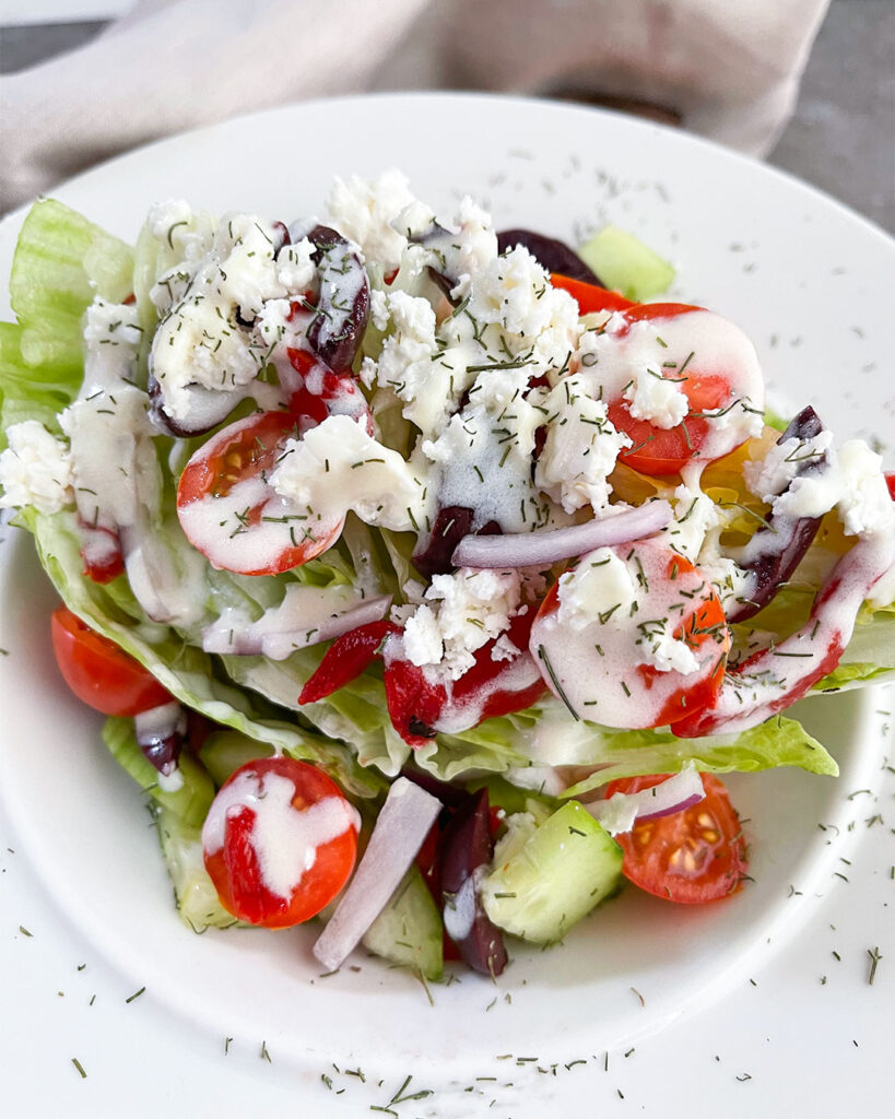 Greek salad with lettuce, tomatoes, cucumbers, onions, feta cheese and dill