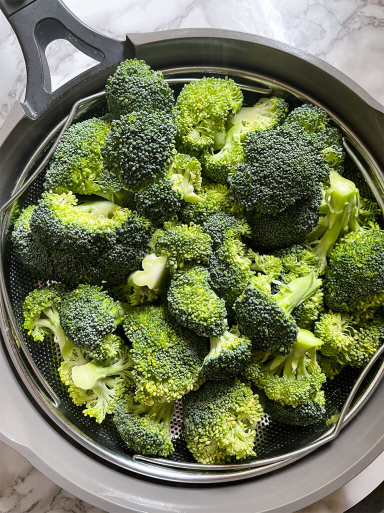 broccoli florets in a steamer basket