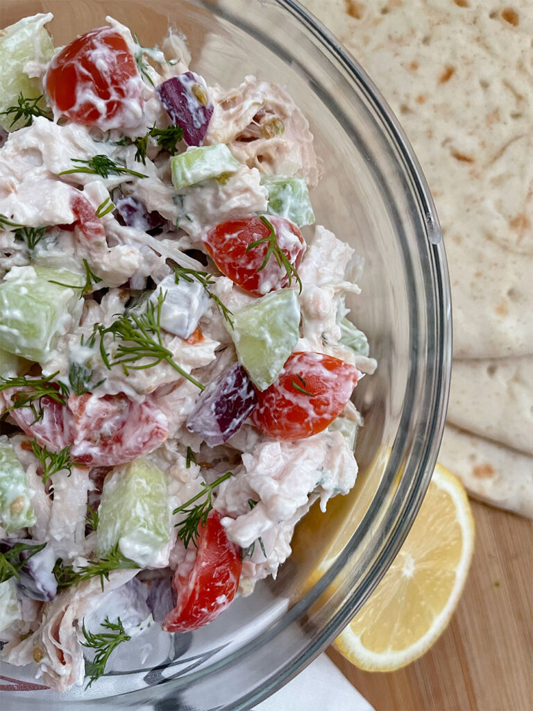 Chicken salad made with greek yogurt, cucumbers, tomatoes, onion and fresh dill