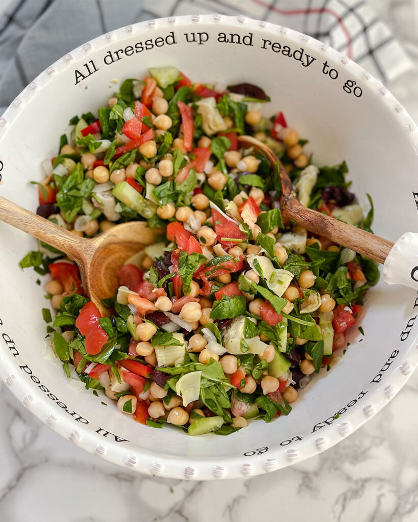 Mediterranean Chickpea Salad ingredients tossed in a bowl
