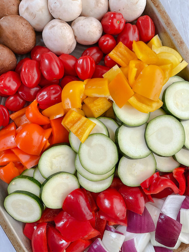 Prepared raw vegetables in a baking sheet