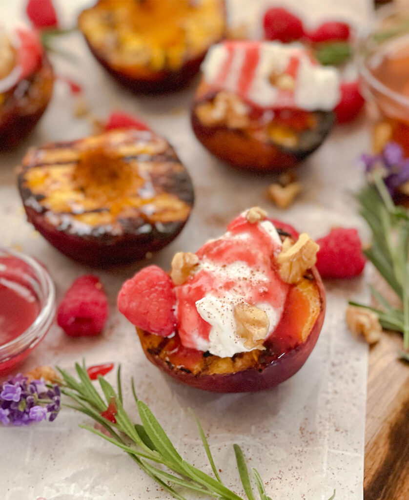 grilled peach halves topped with Greek yogurt, cinnamon and homemade raspberry sauce