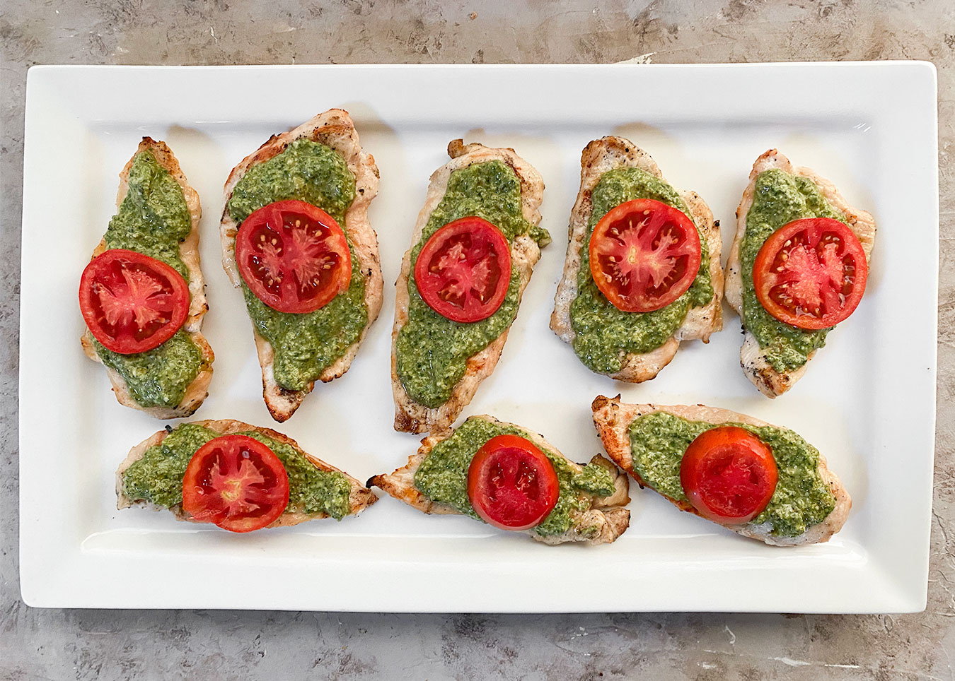 Grilled chicken breasts, pesto and tomatoes