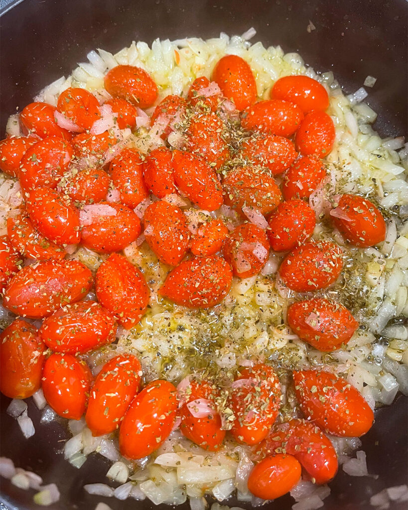 tomatoes with onion and garlic in a sauté pan with spices